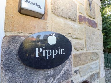 A sign reading Pippin on a stone wall at Pippin in Lucker