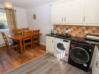 A kitchen with dining table and appliances at Pippin in Lucker
