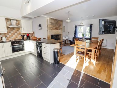 A kitchen with dining area and appliances at Bramley in Lucker