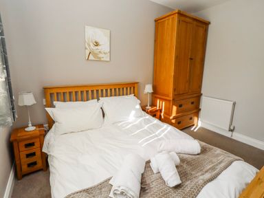 A bedroom with a bed and wardrobe at Bramley in Lucker