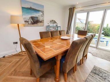 A dining room with a table and chairs at Farne Cottage Beadnell