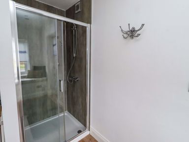 A shower enclosure in a bathroom at Farne Cottage in Beadnell