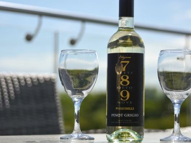 A wine bottle and two empty wine glasses on a table outdoors at The Hemmel (Beadnell) Beadnell