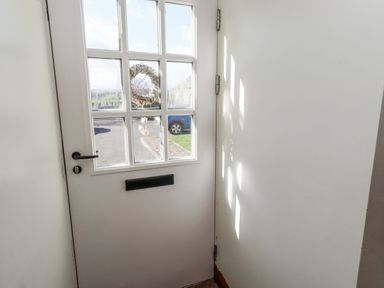 An entrance with a door and window at No9 Budle Sands in Bamburgh