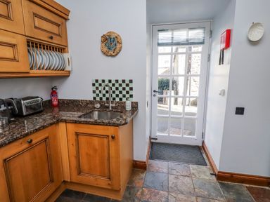 A kitchen with a sink and cabinets at No9 Budle Sands in Bamburgh