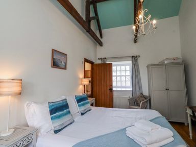 A bedroom with a bed and lamps at No9 Budle Sands in Bamburgh