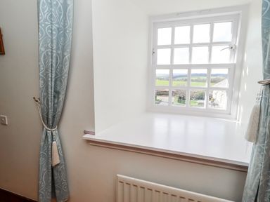 A room with a window and curtains at No9 Budle Sands in Bamburgh
