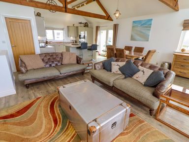 A living room with a sofa and coffee table at Spindrifter Beadnell