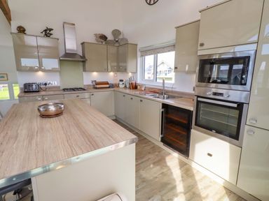 A kitchen with modern cabinets and appliances at Spindrifter Beadnell