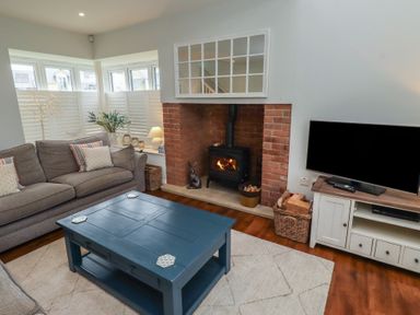 A living room with a coffee table and a television at The Beach Hut Beadnell