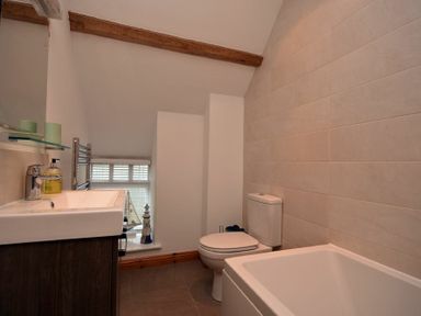 A bathroom with a sink cabinet toilet and bathtub at East Havers in Alnwick