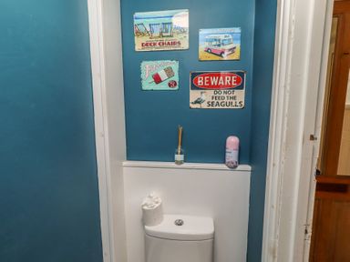 A bathroom with toilet and decorative signs at Number Seventeen Amble