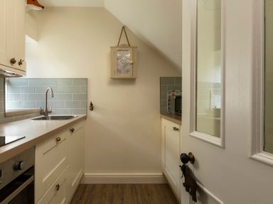 A kitchen with a sink and microwave at Sandpiper in Alnmouth