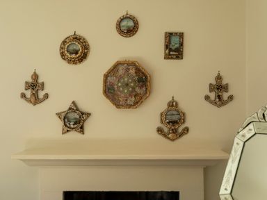 Decorative wall with various picture frames and anchors at Sandpiper (Alnmouth)