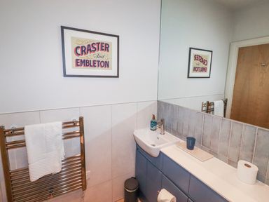 A bathroom with a sink and mirror at Cuddy's Holm in Seahouses