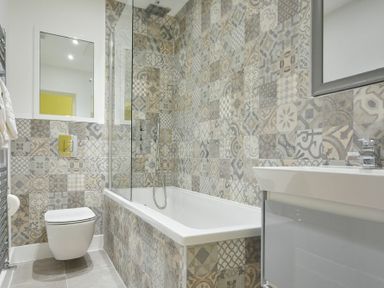 A bathroom with a bathtub shower combination toilet and sink at The Lodge (Alnwick) in Alnwick