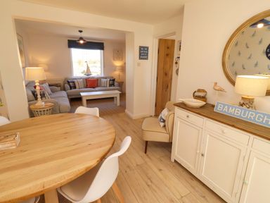 A dining room with a table and chairs at Dunford Cottage Bamburgh