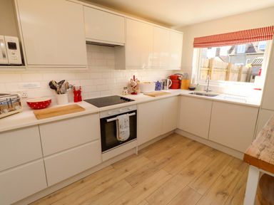 A kitchen with stove and sink at Dunford Cottage in Bamburgh