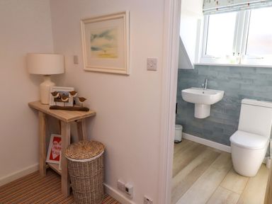 A bathroom with toilet and sink at Dunford Cottage Bamburgh