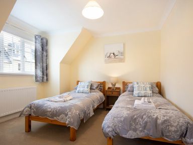 A bedroom with two single beds and a bedside table between them at Castlewood in Bamburgh