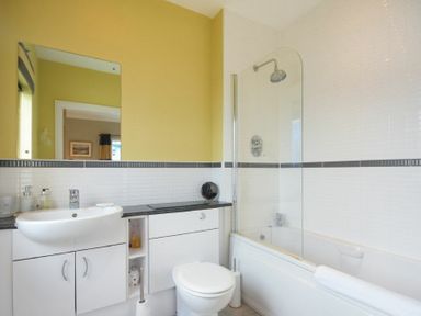 A bathroom with a sink toilet and bathtub at Castle View at the Viking in Seahouses