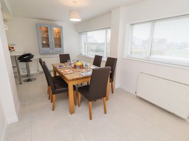 A dining room with a table and chairs at Dell Point in Beadnell