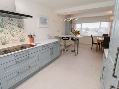 A kitchen with a countertop and dining area at Dell Point Beadnell