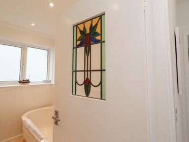 A door with stained glass in a bathroom at Dell Point Beadnell