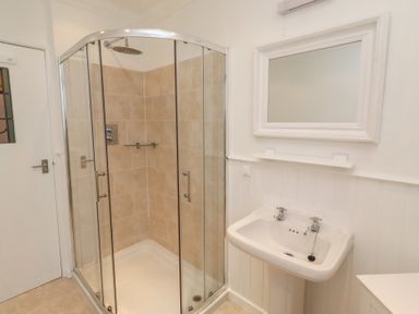 A bathroom with a shower and sink at Dell Point in Beadnell