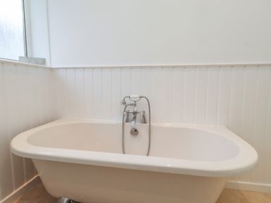A bathroom with a freestanding bath tub and faucet at Dell Point in Beadnell
