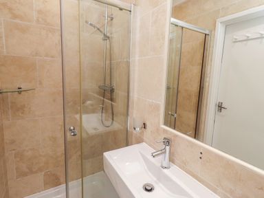 A bathroom with a shower and sink at Dell Point in Beadnell