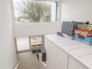 A staircase with games and a window at Dell Point Beadnell