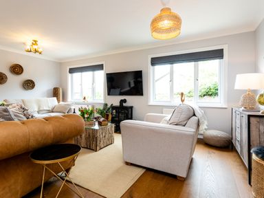 A living room with sofas tv and coffee table at Polished Pebble in Beadnell