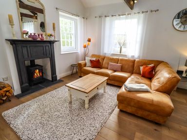 A living room with a sofa and a coffee table at Treetops, Alnwick