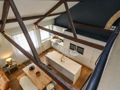 A kitchen with an island and appliances at Treetops, Alnwick
