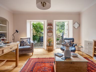 A living room with a table and chairs at Westhill House in Warkworth