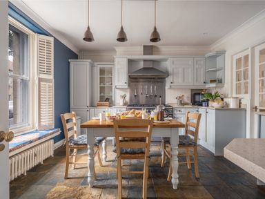 A kitchen with a dining table and chairs at Westhill House in Warkworth