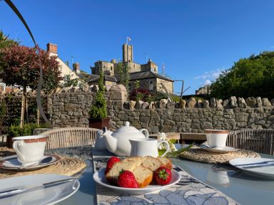 An outdoor table set with tea and snacks at Westhill House in Warkworth