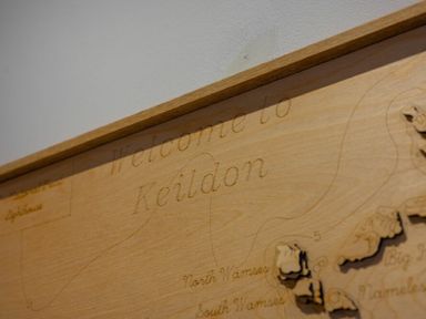 A wooden carved map with the text welcome to Keildon