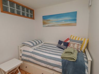 A bedroom with a bed against a wall at Links View, Embleton