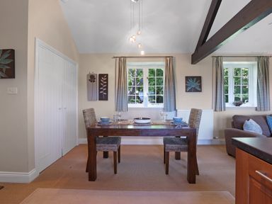 A dining room with a table and chairs at Plumtree Cottage in Alnmouth