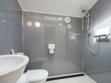 A bathroom with a sink toilet and shower area at Lobster Pot Cottage in Seahouses