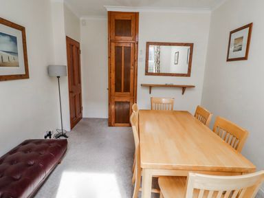 A dining room with a wooden table and chairs at Hardys House in Alnwick