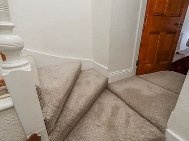 A staircase leading to a hallway at Hardys House Alnwick