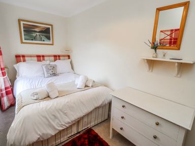 A bedroom with a bed and a dresser at Hardys House in Alnwick