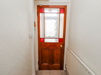 A door with glass panels in a hallway at Hardys House in Alnwick
