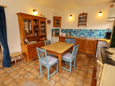 A kitchen with wooden furniture and appliances at Lavender Cottage (Bailiffgate) Alnwick