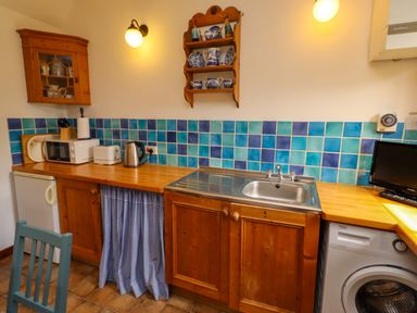 A kitchen with a sink and appliances at Lavender Cottage (Bailiffgate) Alnwick