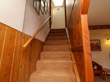 A staircase with carpet and framed pictures at Lavender Cottage (Bailiffgate) Alnwick