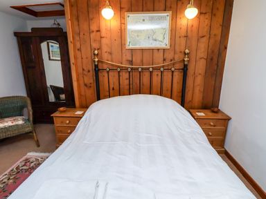 A bedroom with a bed and nightstands at Lavender Cottage (Bailiffgate) Alnwick